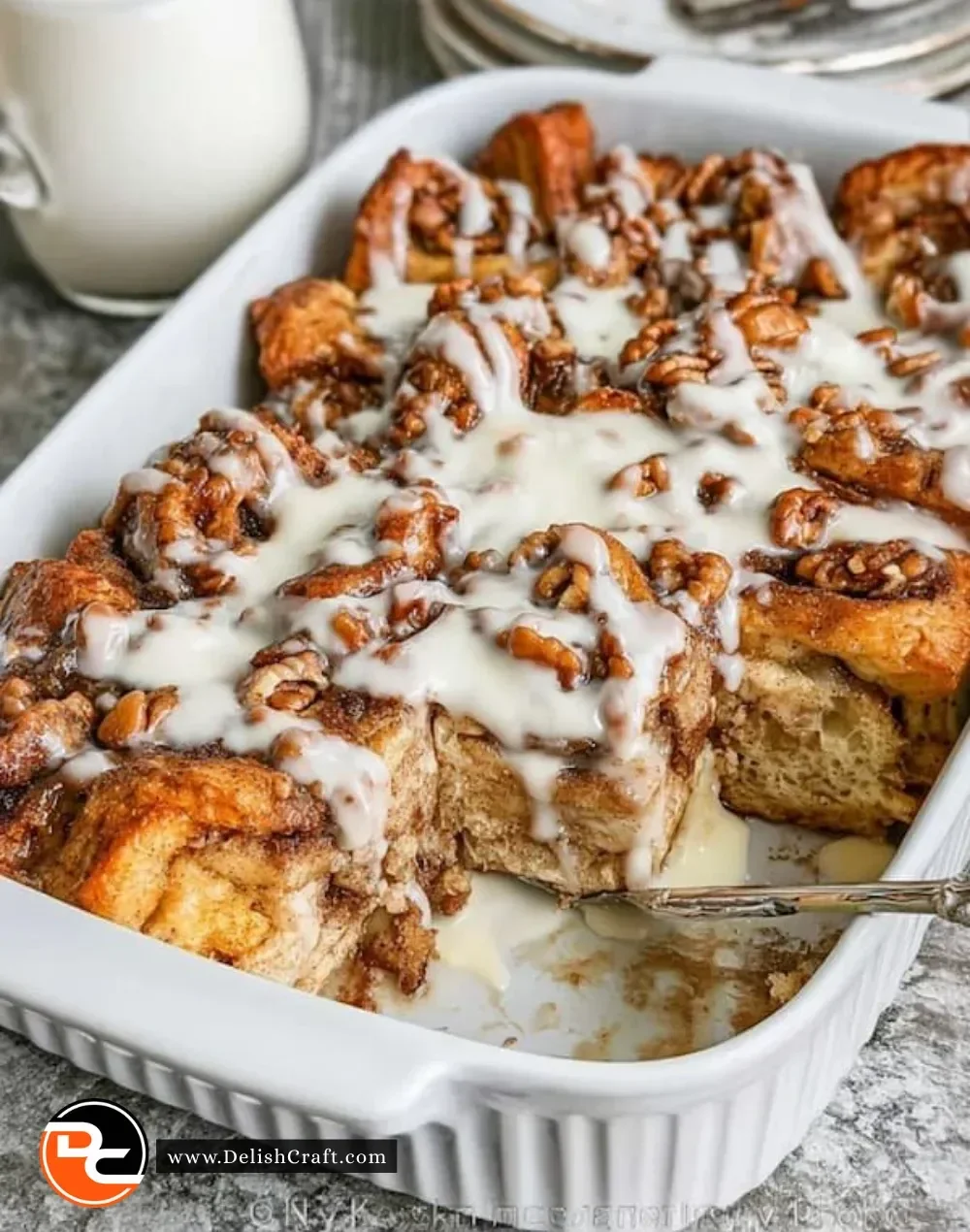 Cinnamon Roll French Toast Casserole topped with icing and cinnamon sugar