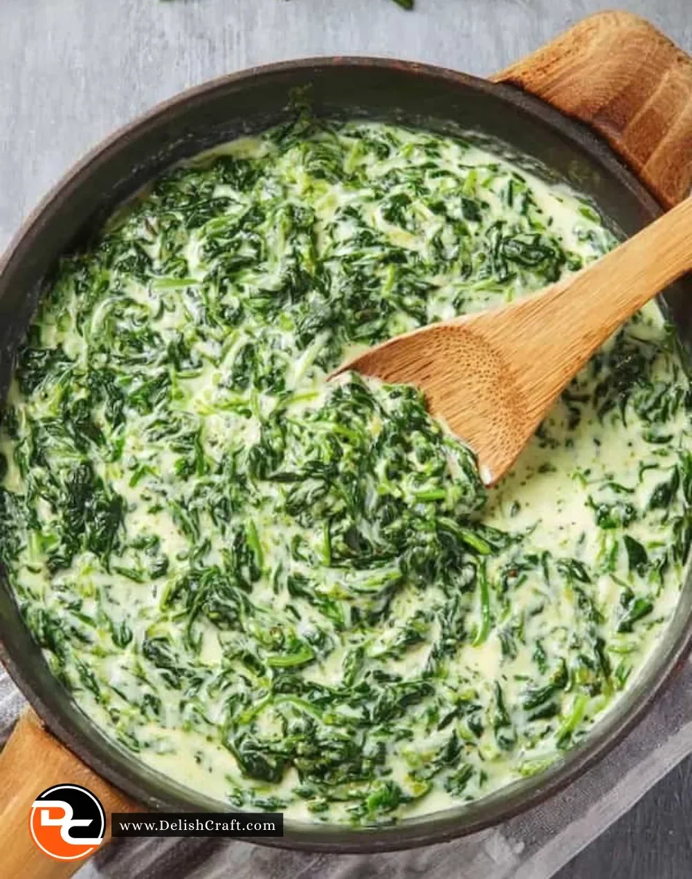 Bowl of easy creamed spinach on a dining table
