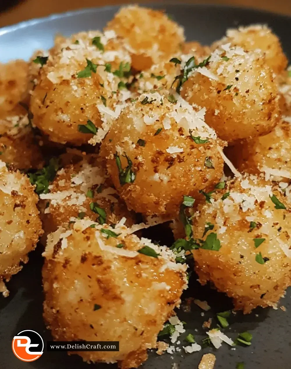 Easy crispy garlic parmesan bites on a platter with herbs