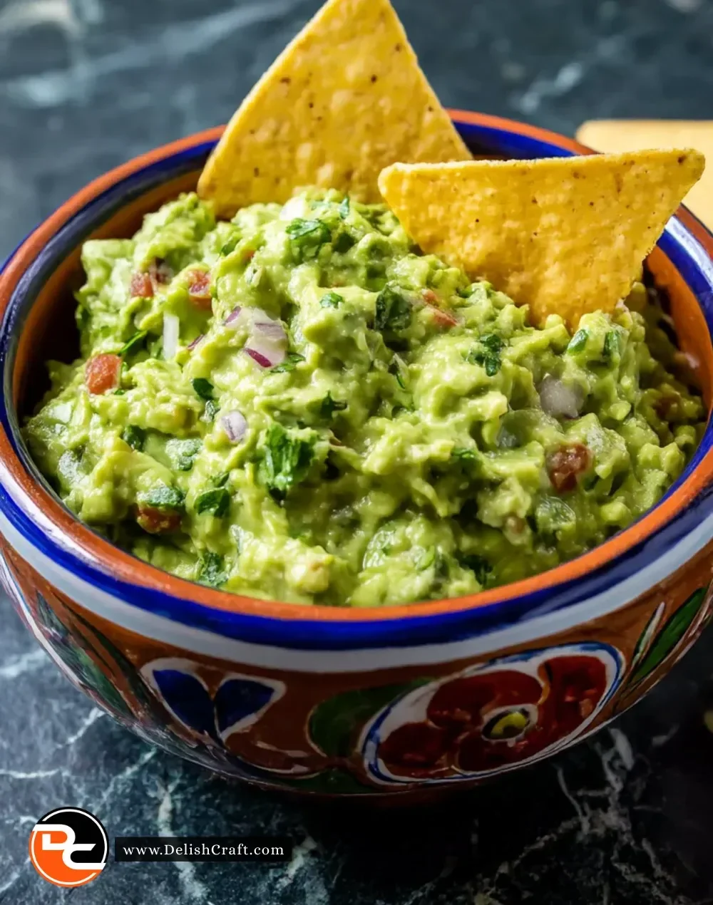 Bowl of perfect guacamole with fresh ingredients and tortilla chips