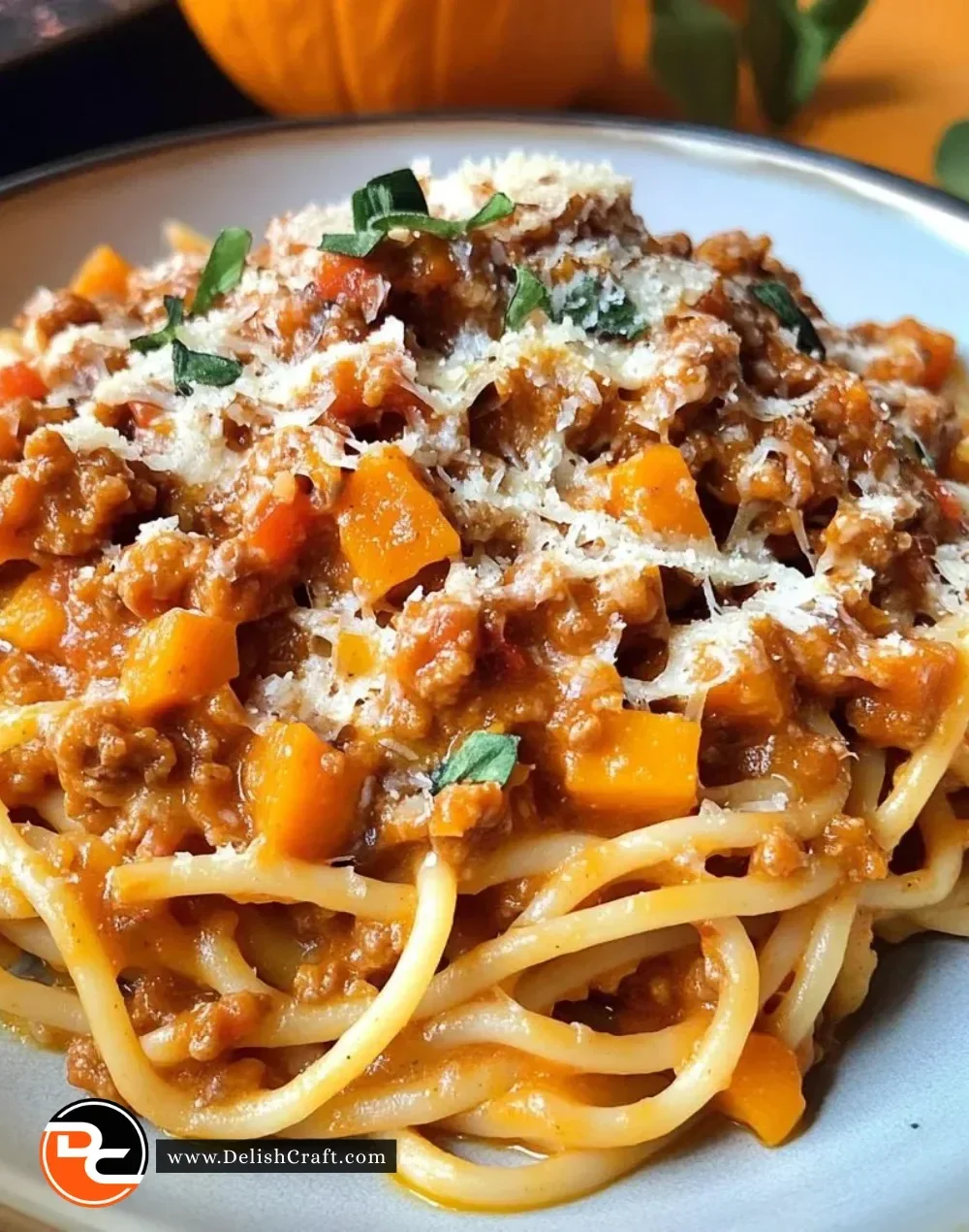 Delicious bowl of Pumpkin Bolognese served with pasta and herbs.