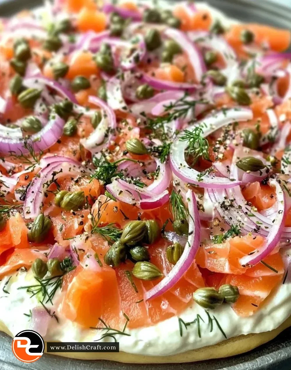 A bowl of smoked salmon dip served with bagels and fresh herbs.