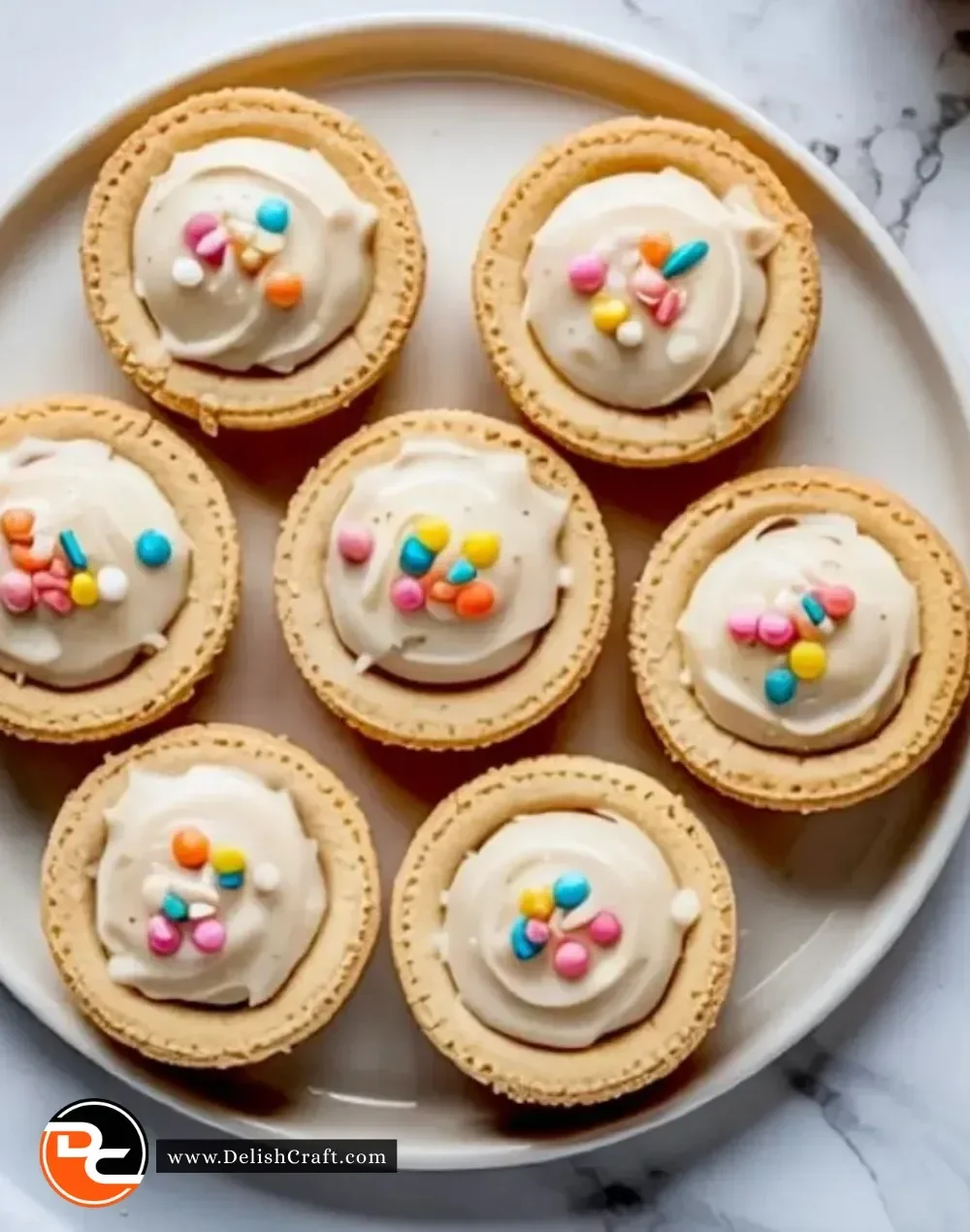 Sugar cookie cups topped with vanilla frosting ready to be enjoyed.