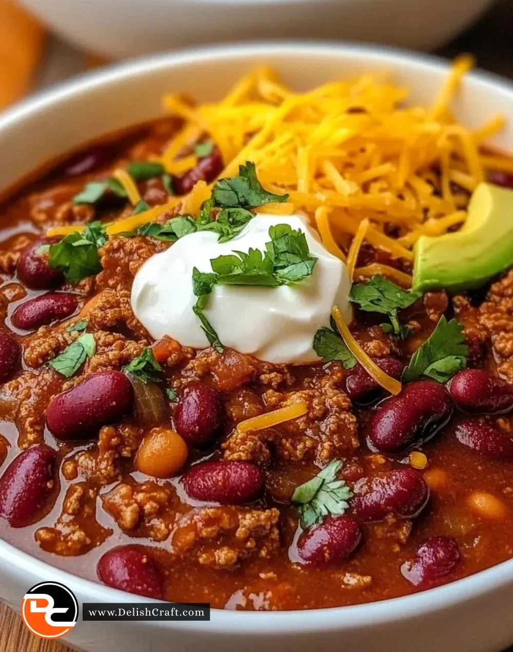Bowl of Texas Roadhouse Chili topped with cheese and green onions