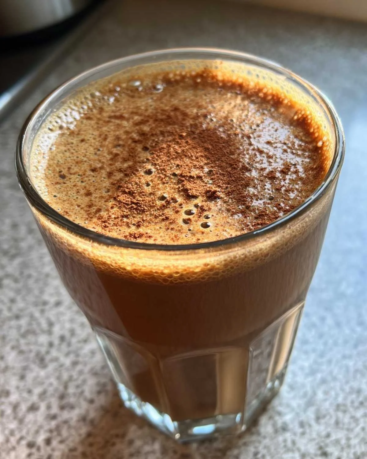 Delicious gingerbread smoothie served in a glass with festive toppings