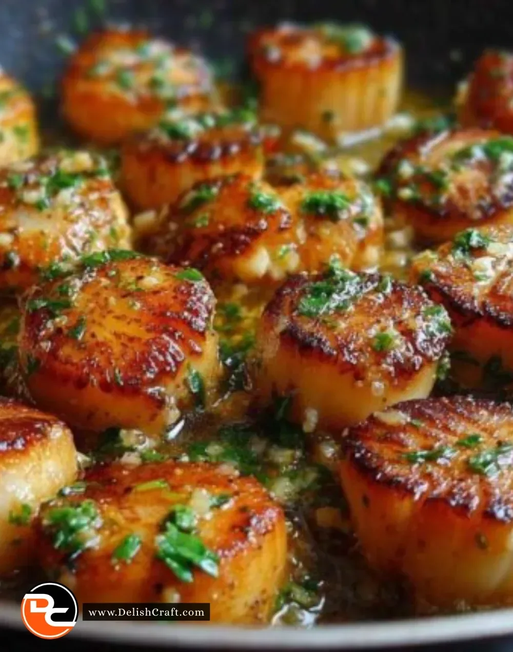 Delicious garlic lemon scallops served on a plate with garnish.