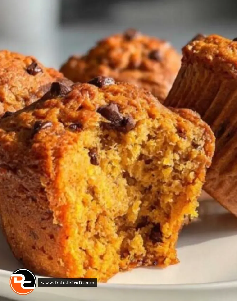 Delicious pumpkin chocolate chip muffins topped with melted chocolate chips