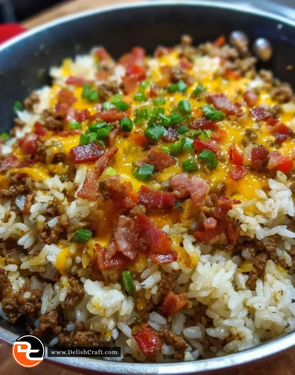 Bacon cheeseburger rice skillet topped with melted cheese and crispy bacon