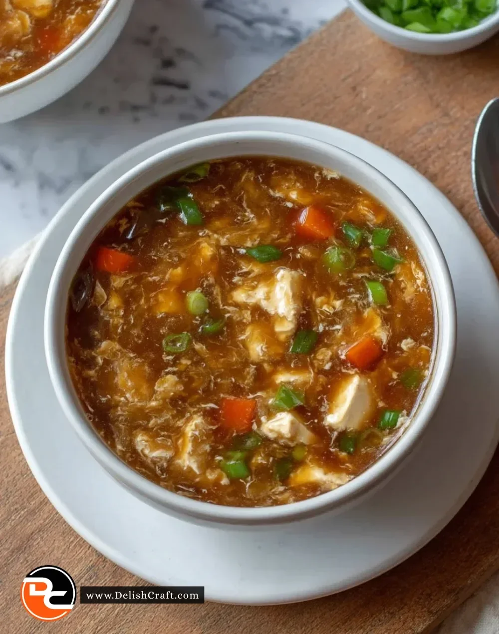 Bowl of classic hot and sour soup with ingredients including mushrooms and tofu