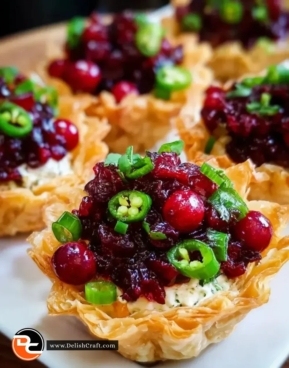 Delicious Cranberry Jalapeño Dip Tarts garnished with fresh herbs