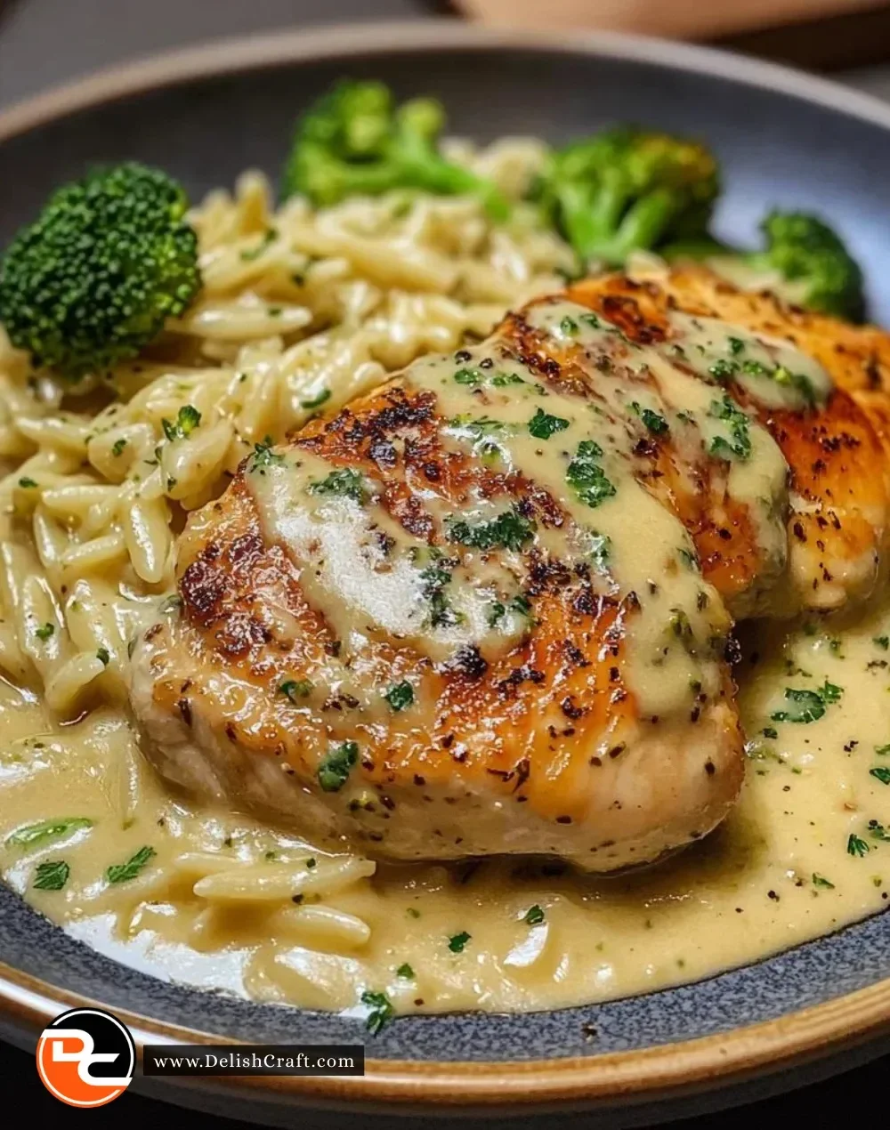 Creamy Chicken Broccoli Orzo dish served in a bowl, garnished with fresh herbs