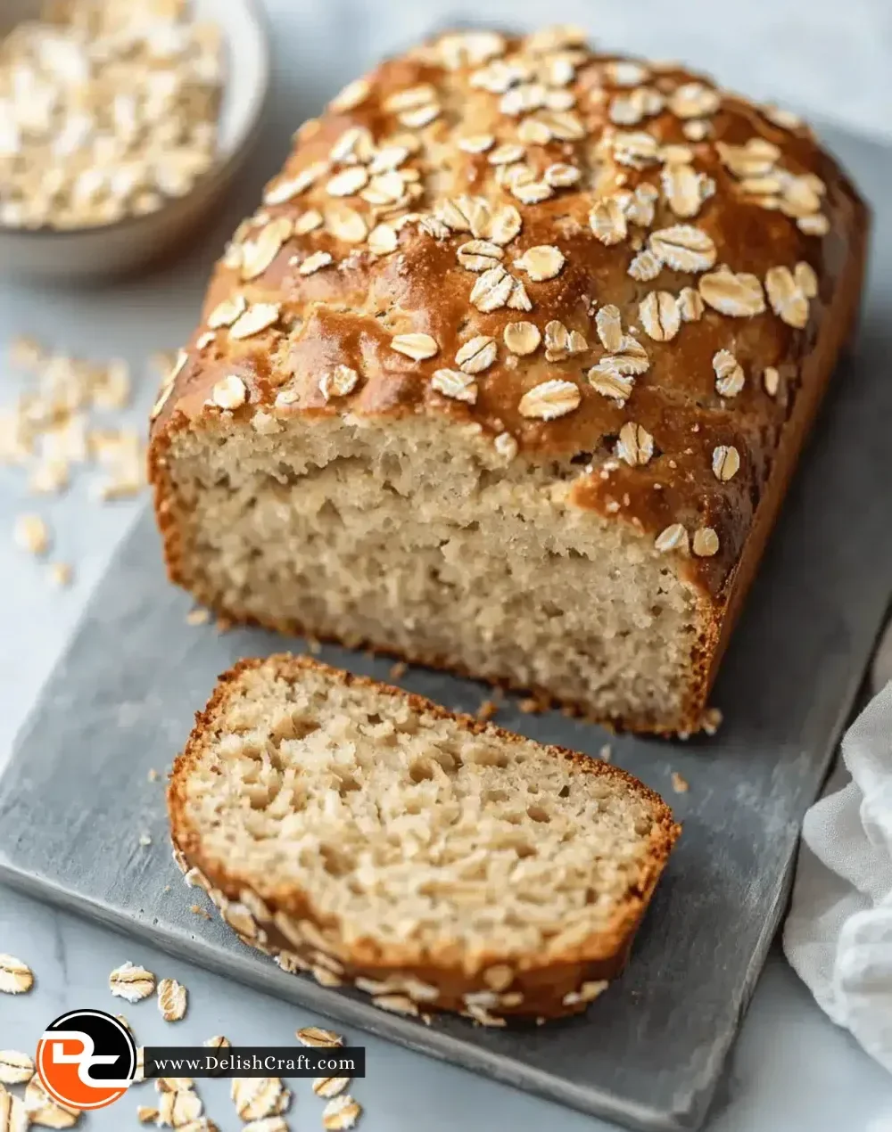 Homemade Greek yogurt oat bread sliced on a wooden board.