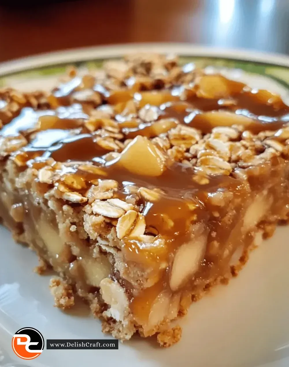 Delicious homemade easy caramel apple oat bars on a wooden table.