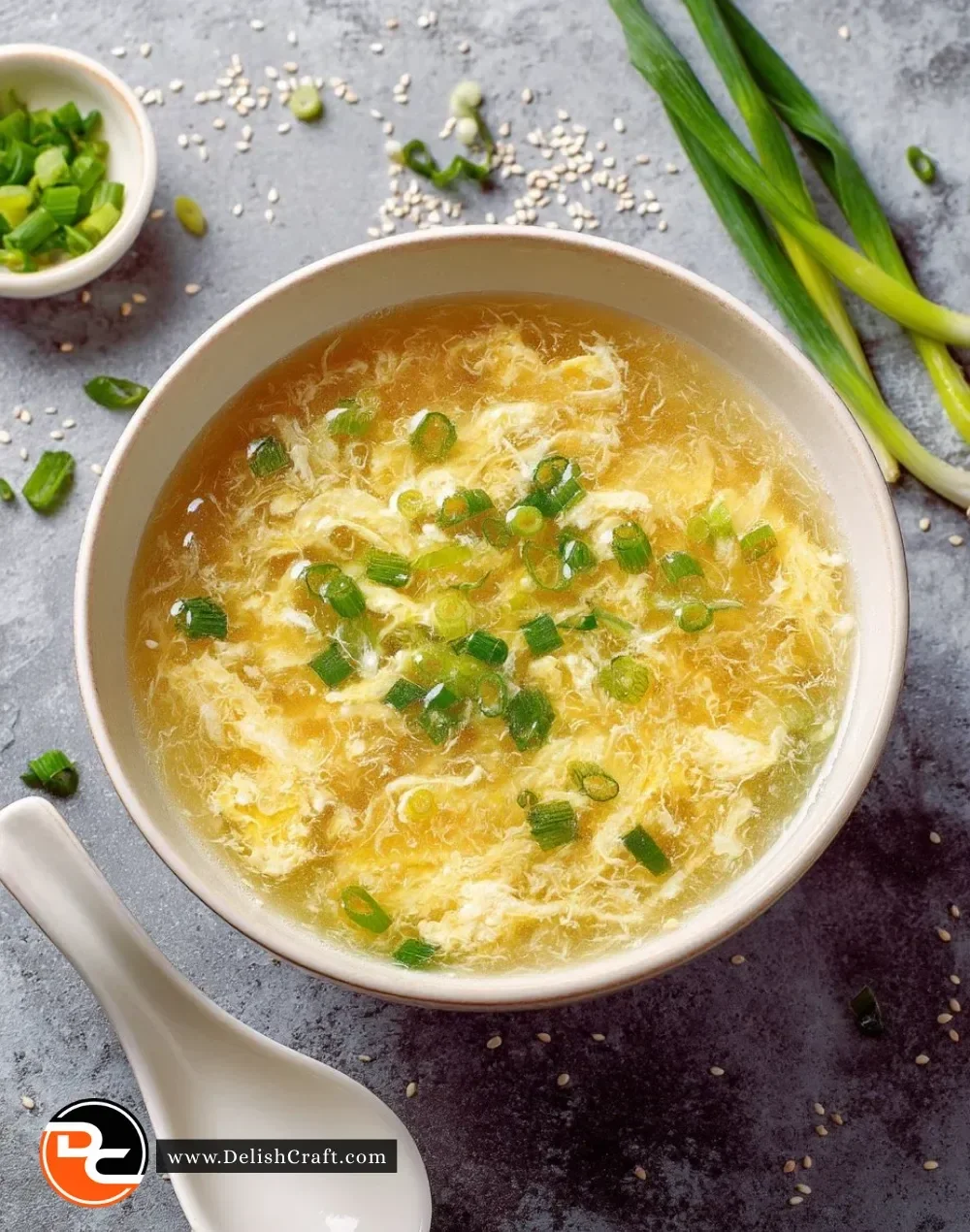 Bowl of easy egg drop soup garnished with green onions