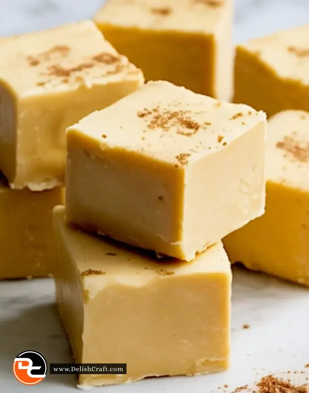Deliciously creamy and festive easy Eggnog Fudge dessert piece on a plate