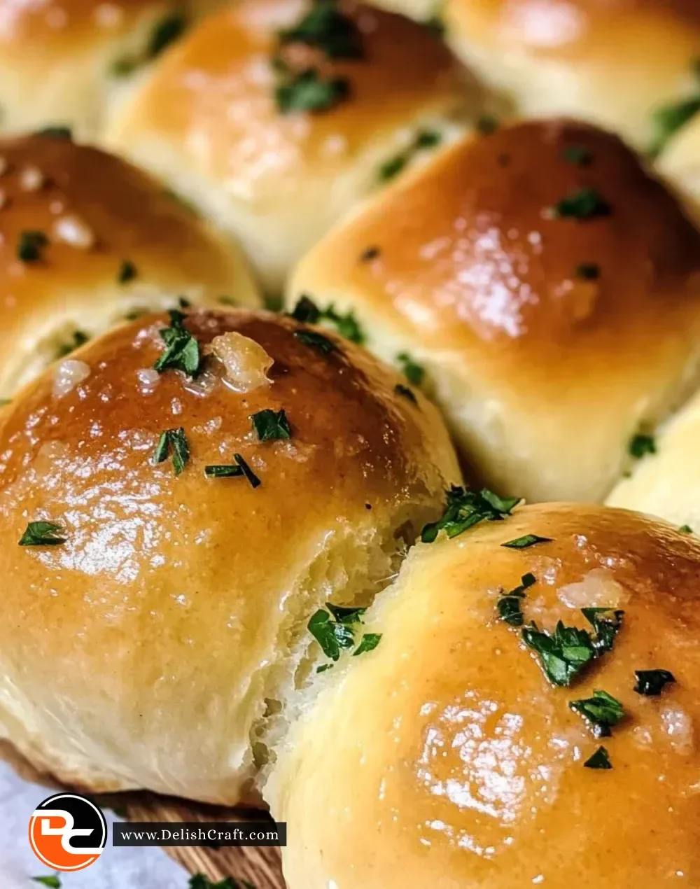 Freshly baked easy garlic butter dinner rolls on a wooden table