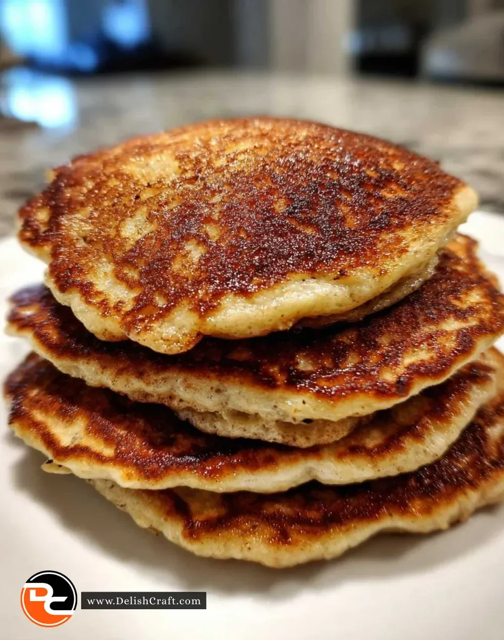 Fluffy banana bread pancakes stacked with syrup and bananas on a plate