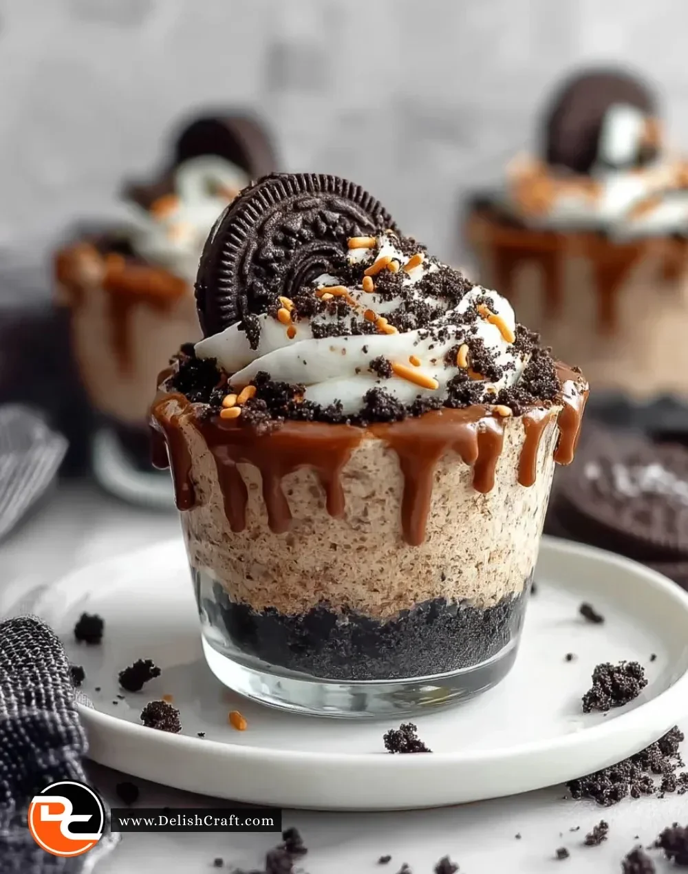 Graveyard Dirt Cake Cups decorated with gummy worms and cookie crumbles