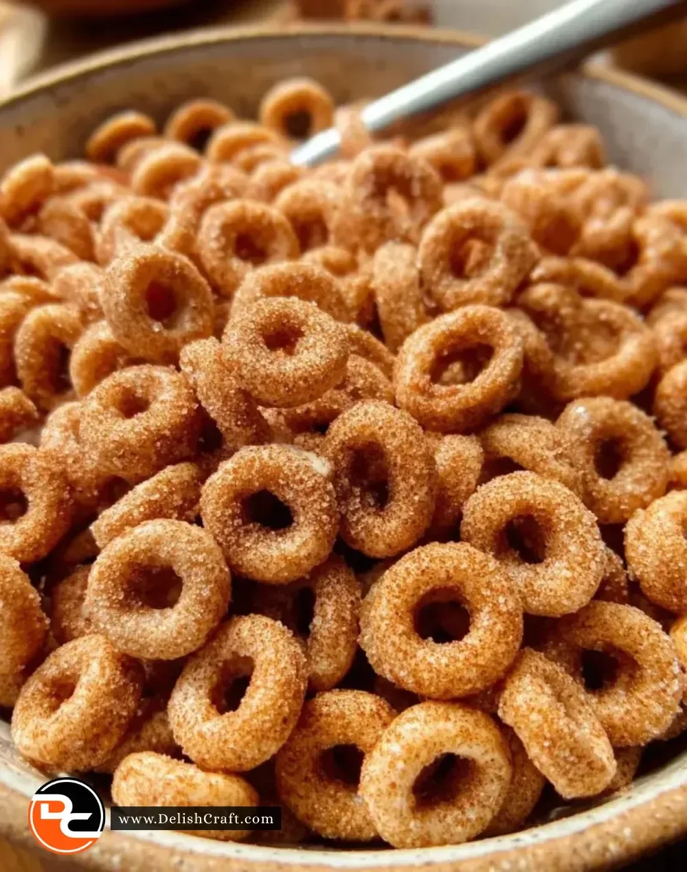 Bowl of Hot Buttered Cinnamon Cheerios topped with cinnamon and butter