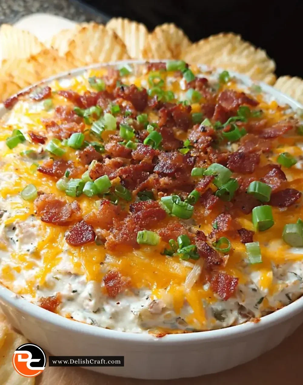 Creamy loaded baked potato dip served with crispy bacon and chives.