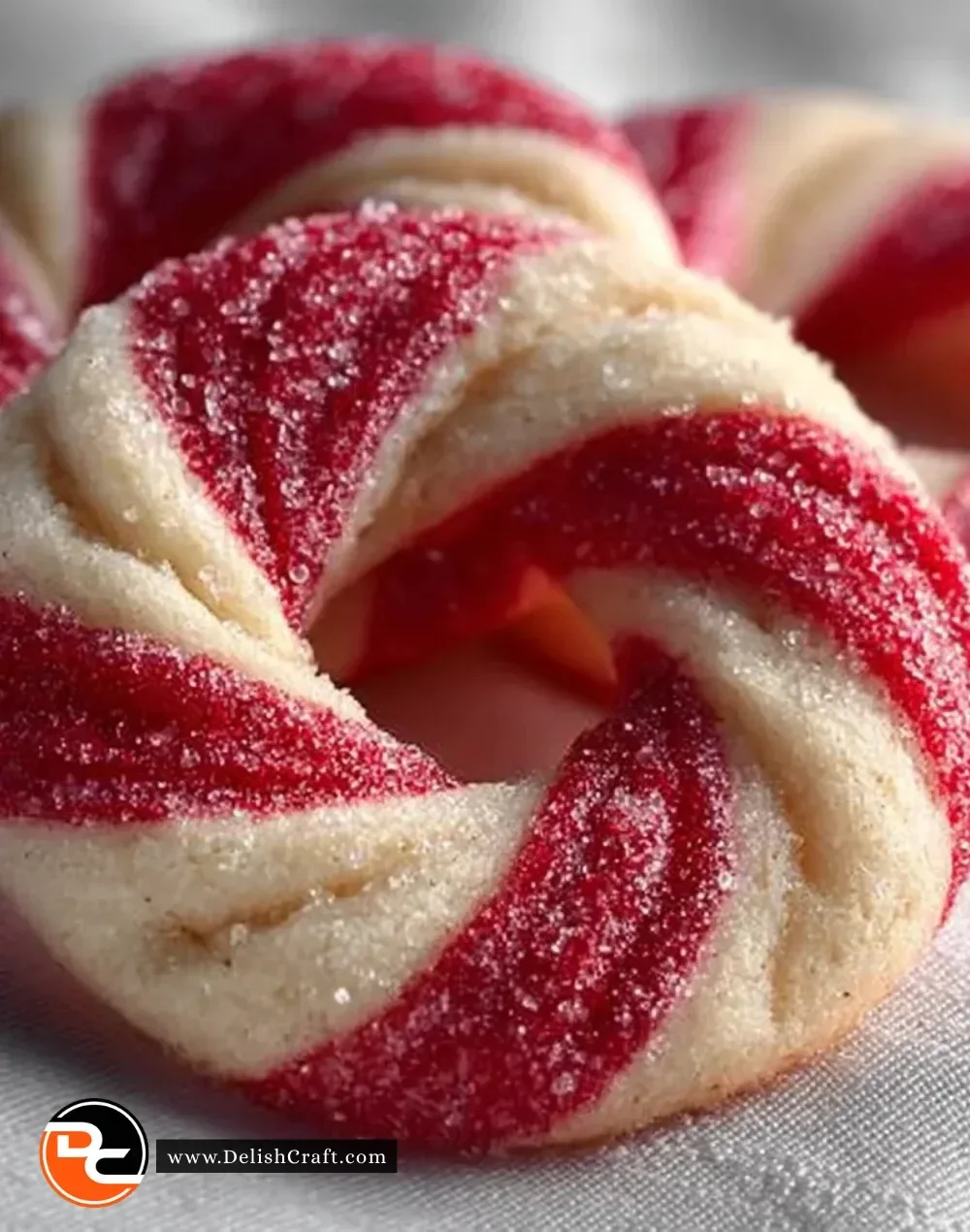 A plate of festive candy cane cookies decorated with red and white icing.