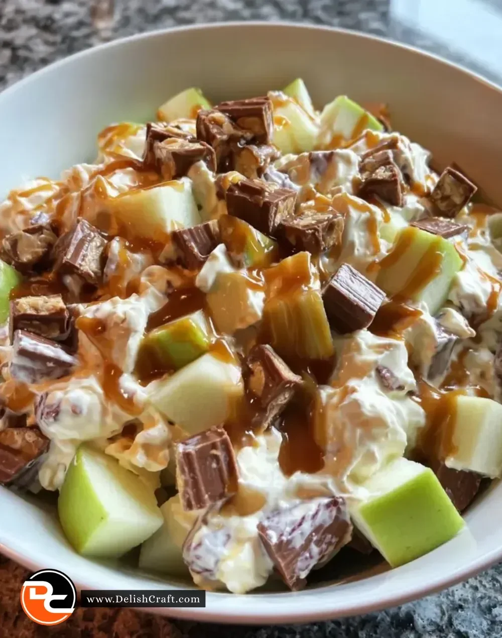 Delicious Snickers Caramel Apple Salad with apples, caramel, and Snickers bar pieces