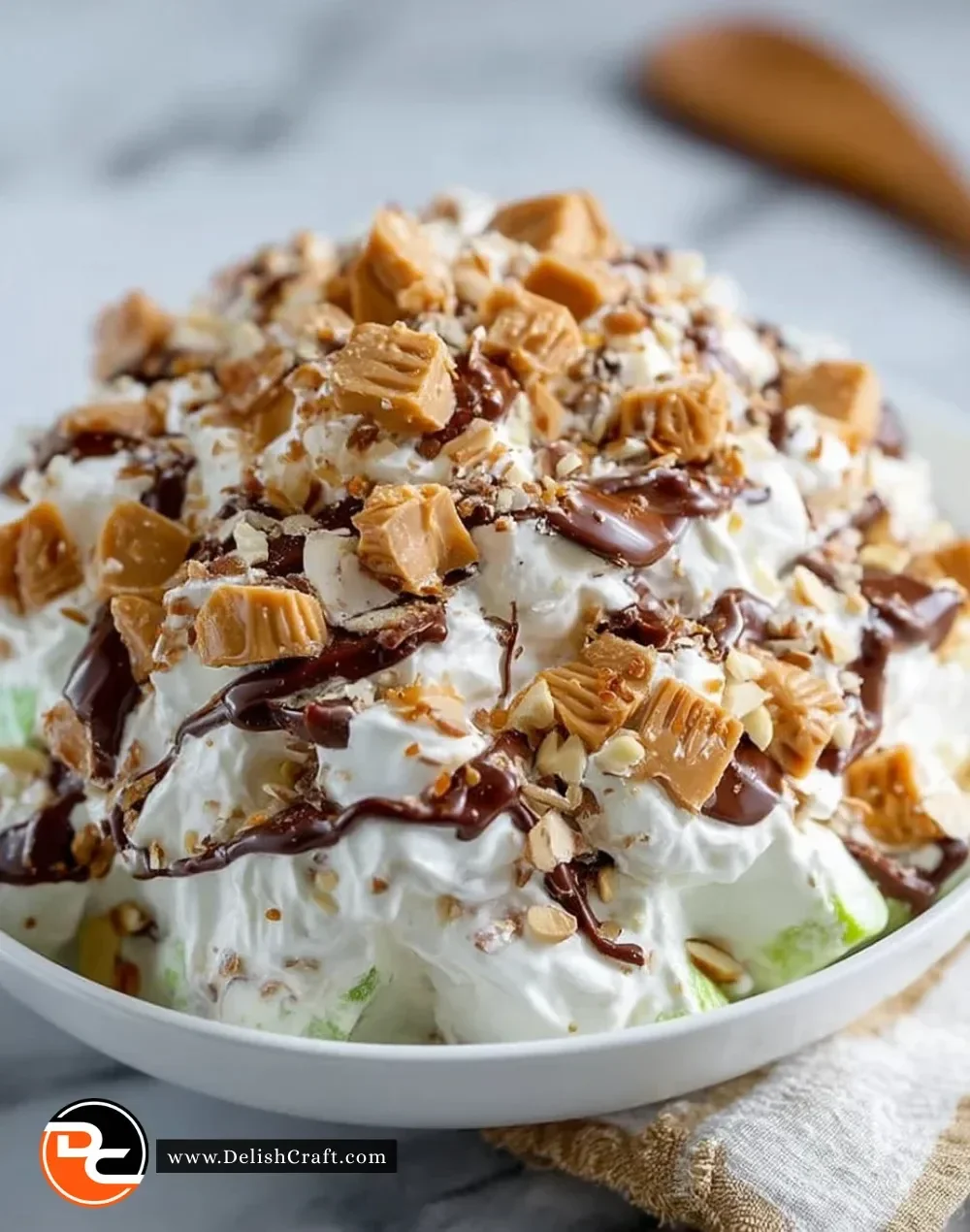 Delicious Snickers Salad with apples, Snickers bars, and whipped cream