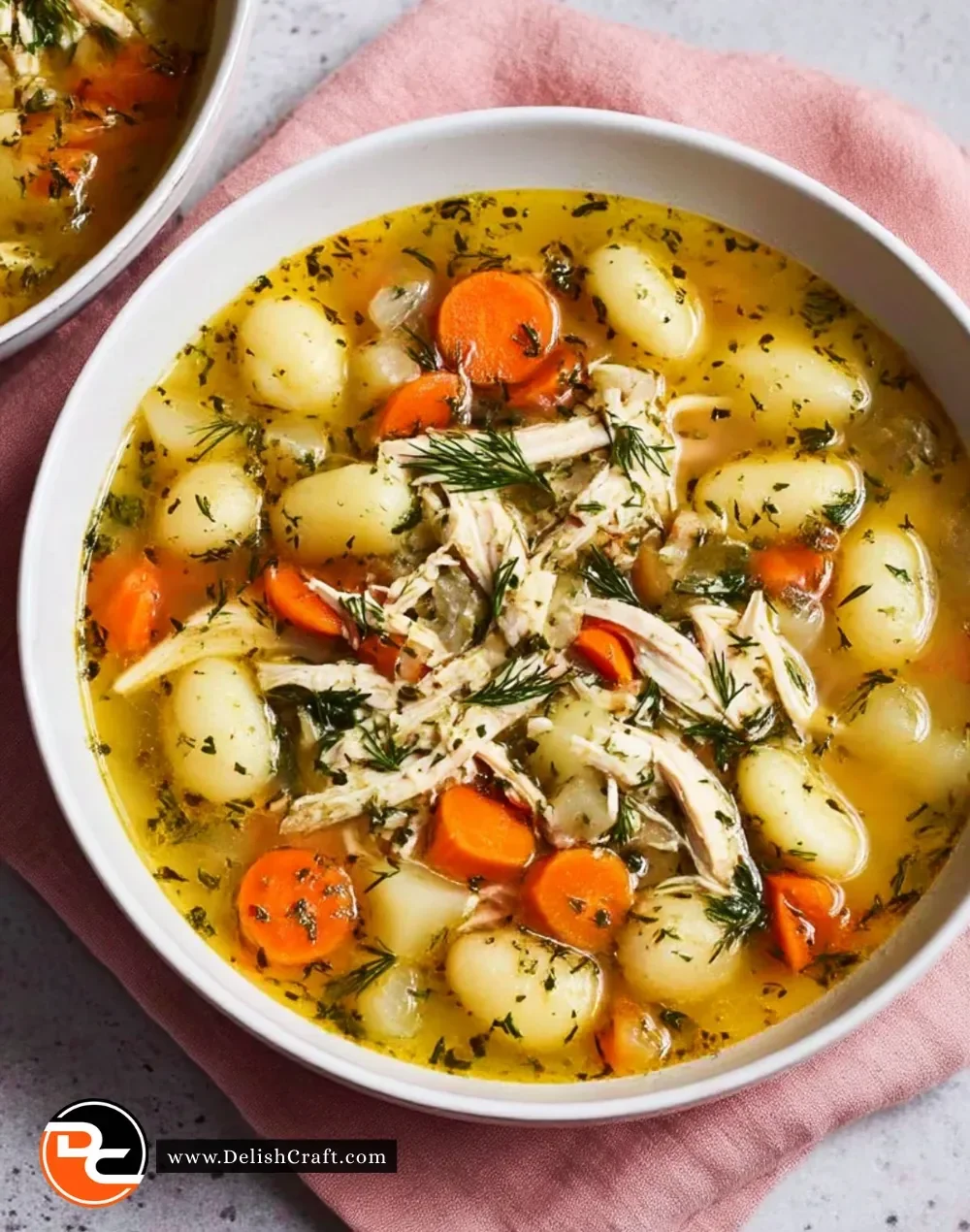 Bowl of Spring Chicken Gnocchi Soup with herbs and vegetables