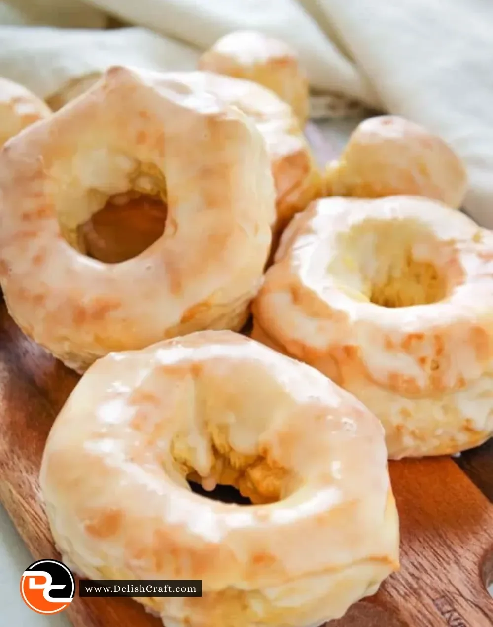 A plate of freshly made air fryer donuts topped with icing and sprinkles