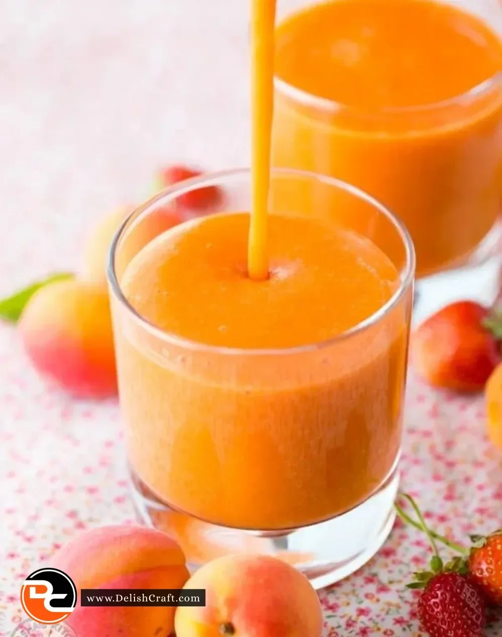 Delicious and refreshing apricot smoothie in a glass with fresh apricots