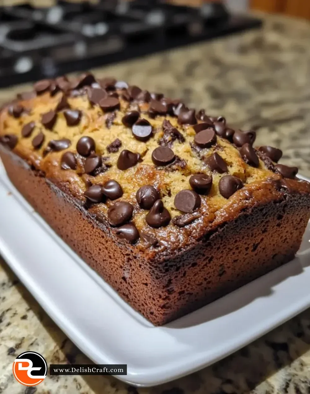Slice of the best ever chocolate chip banana bread with chocolate chips and bananas.