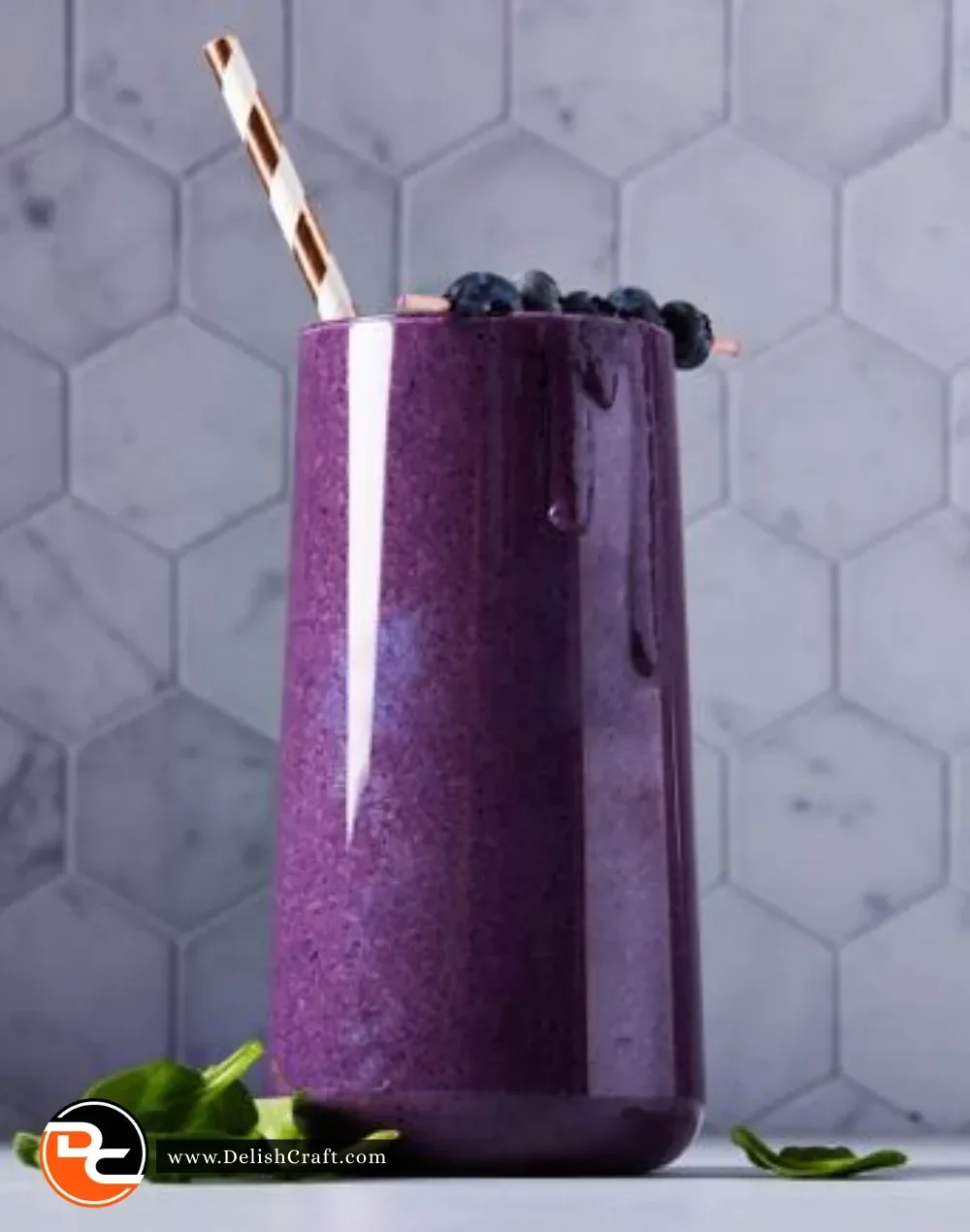 Delicious blueberry smoothie in a glass with fresh blueberries on the side