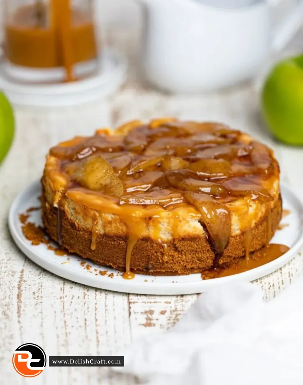 Delicious slice of Caramel Apple Cheesecake topped with caramel and apple slices