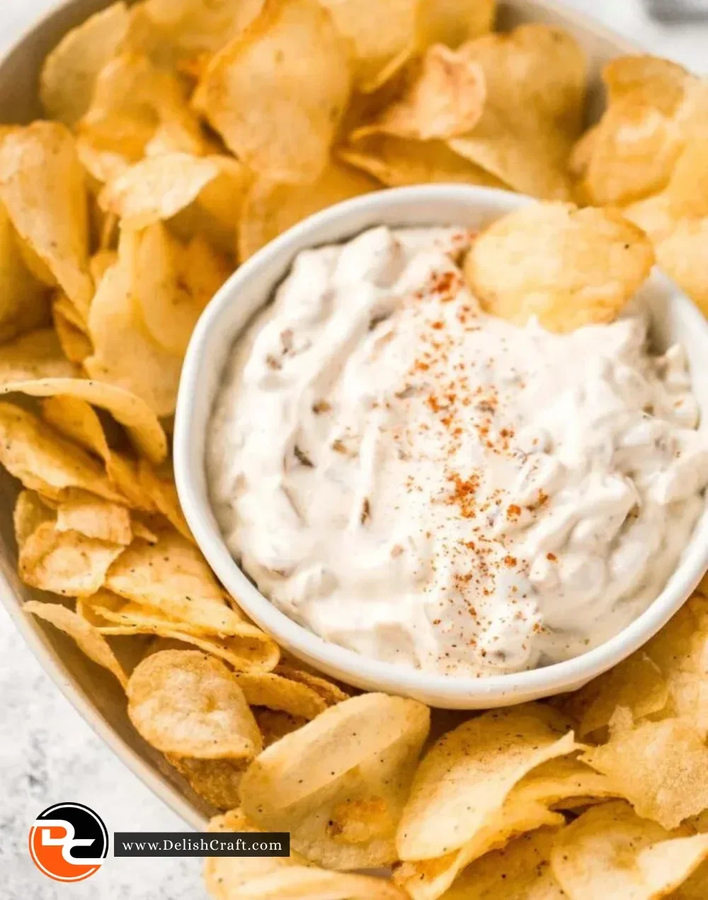 Delicious caramelized onion dip served with chips and veggies