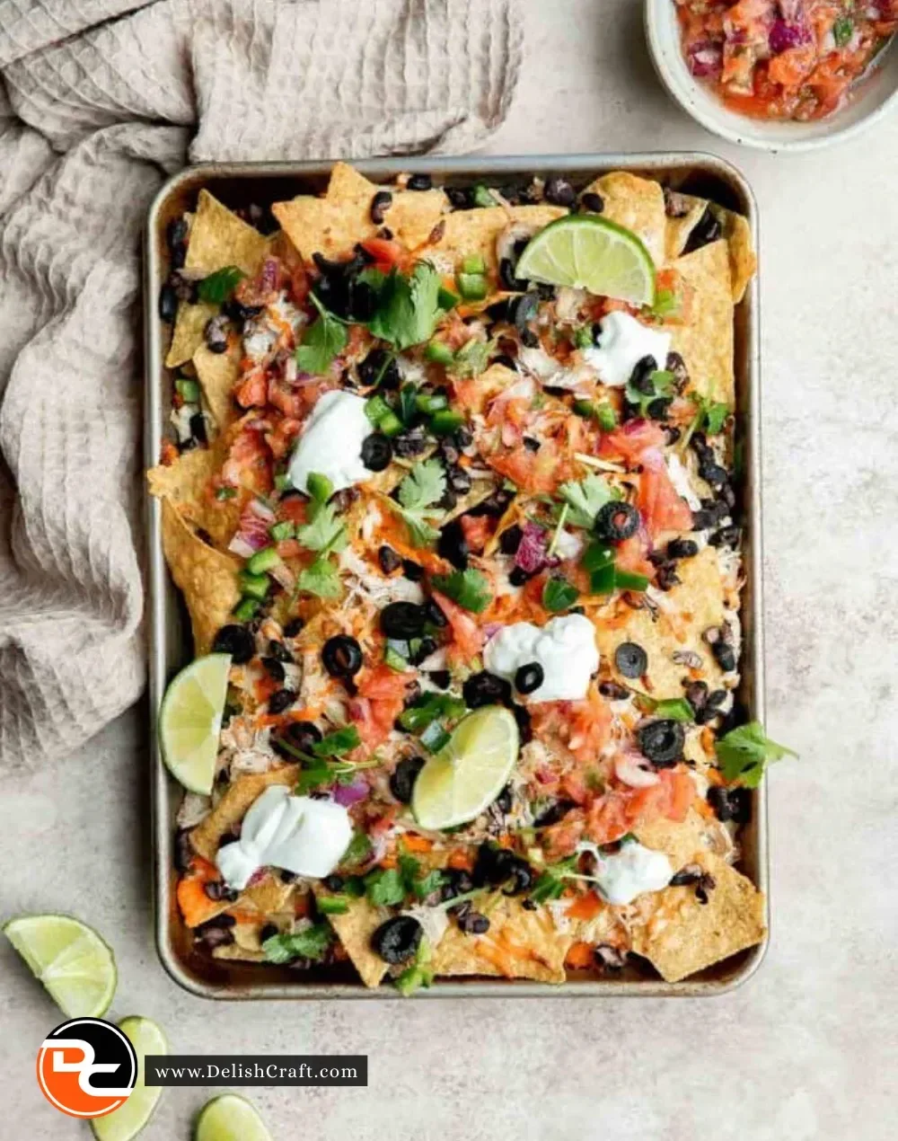 Plate of loaded Chicken Nachos with cheese, jalapeños, and toppings