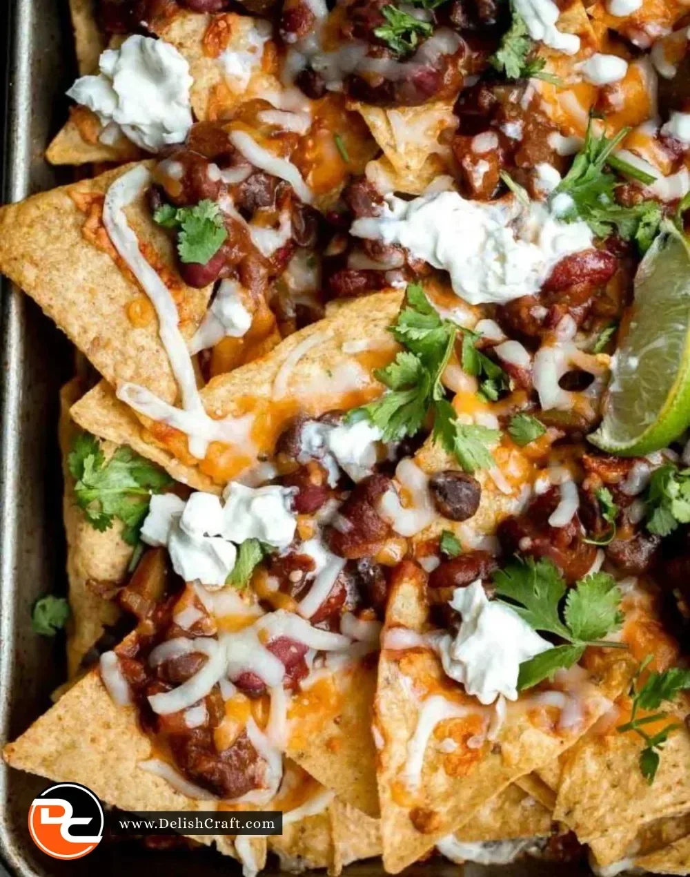 Plate of spicy chili nachos topped with melted cheese and fresh jalapeños