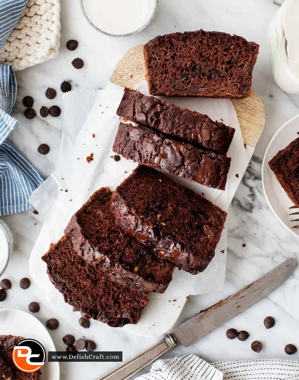 Delicious chocolate zucchini bread slice on a plate with chocolate chips
