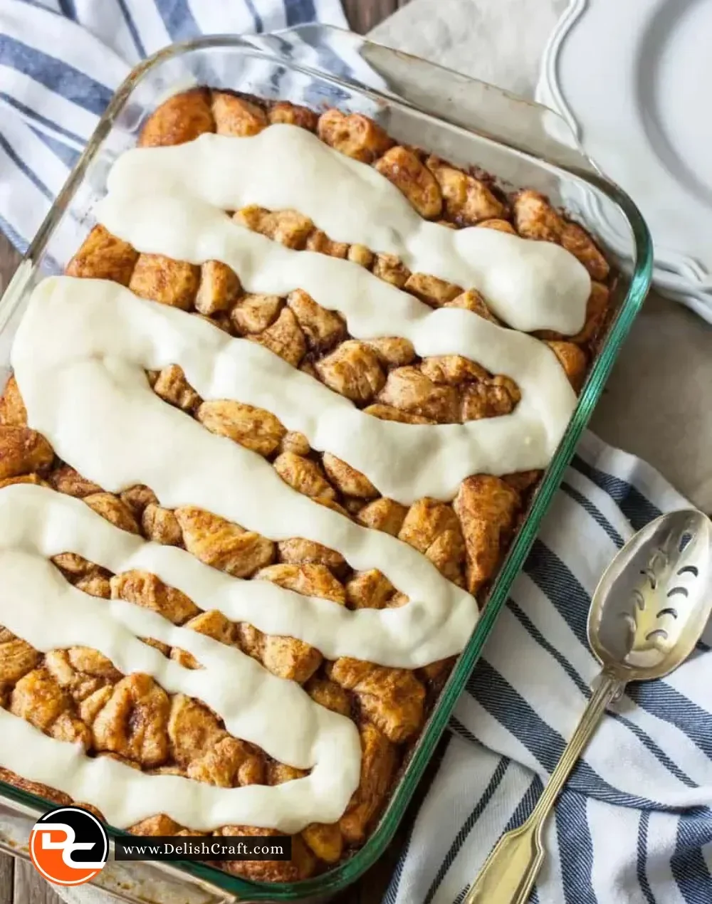 Baked cinnamon roll casserole topped with icing and cinnamon sugar