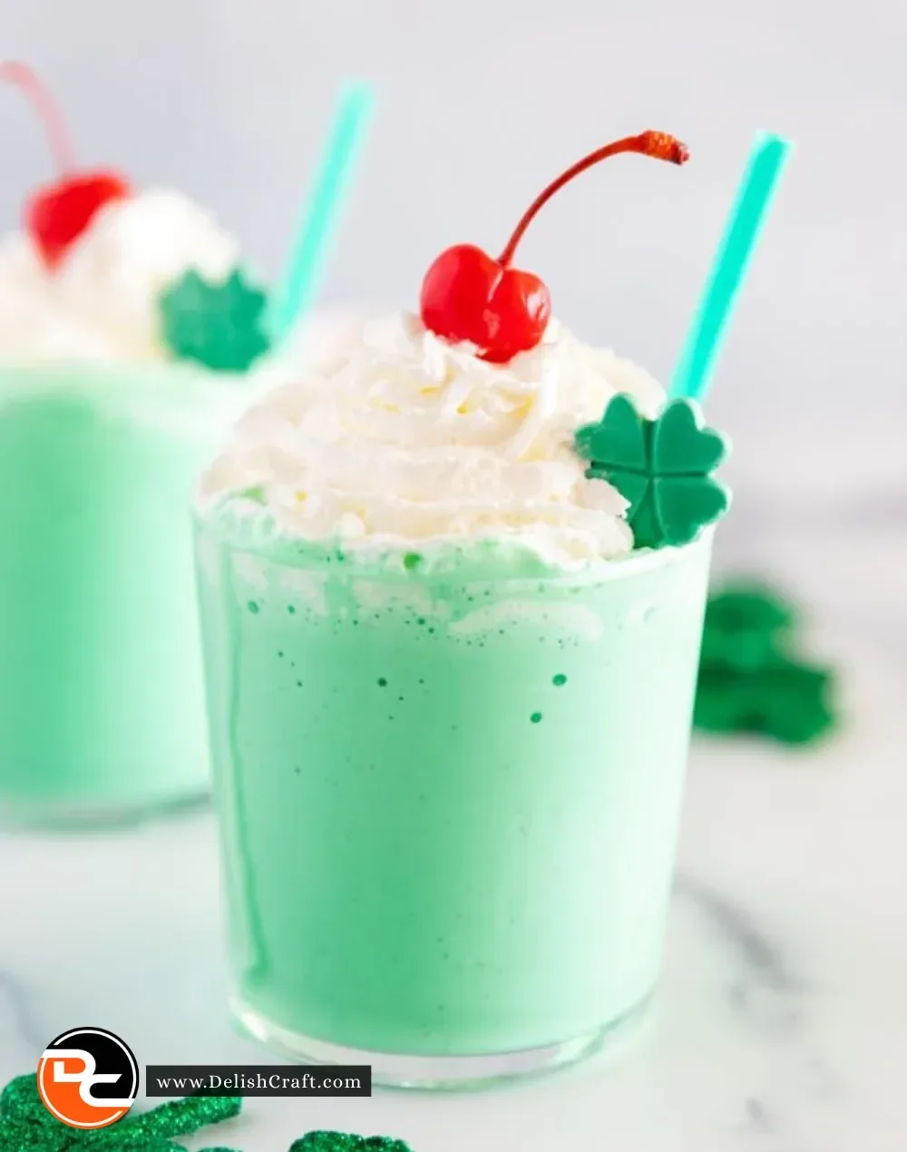 Homemade Copycat Shamrock Shake in a glass topped with whipped cream and a cherry