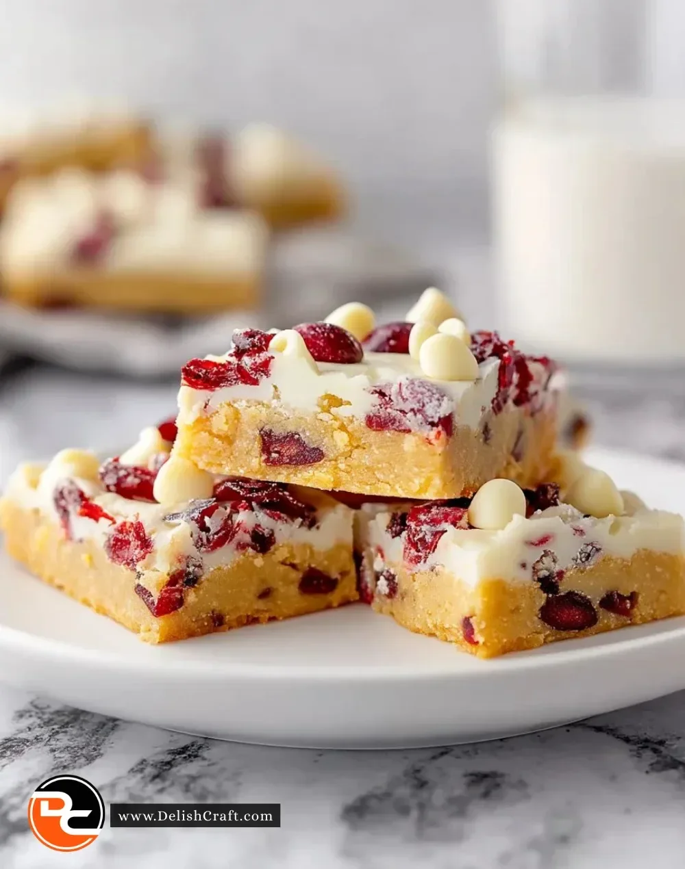 Delicious homemade Cranberry Bliss Bars topped with cream cheese frosting and cranberries