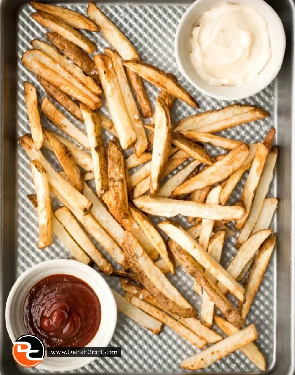 Crispy air fryer French fries served in a bowl with a dipping sauce.