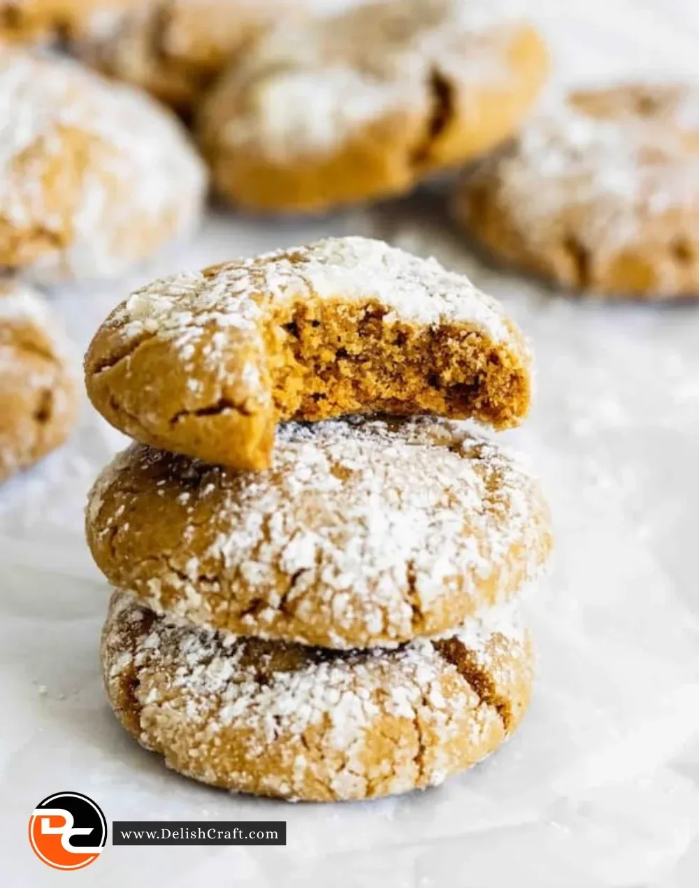 Freshly baked gingerbread crinkle cookies dusted with powdered sugar