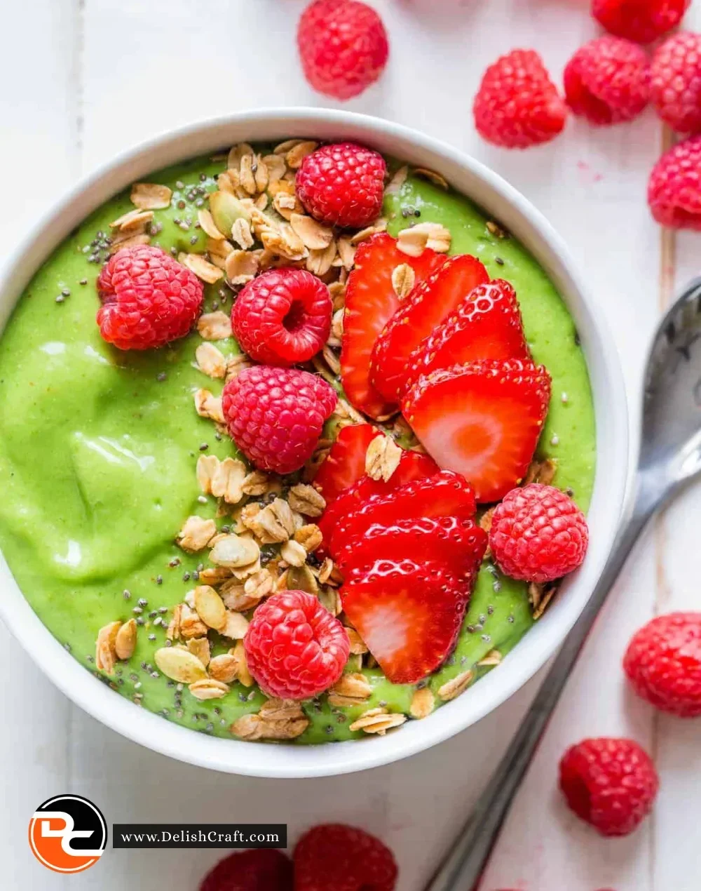 Delicious green smoothie in a glass garnished with fresh fruits and greens