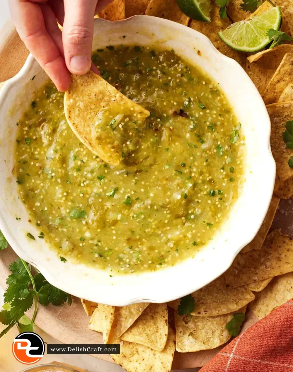 Fresh green tomatillo salsa served in a bowl with tortilla chips