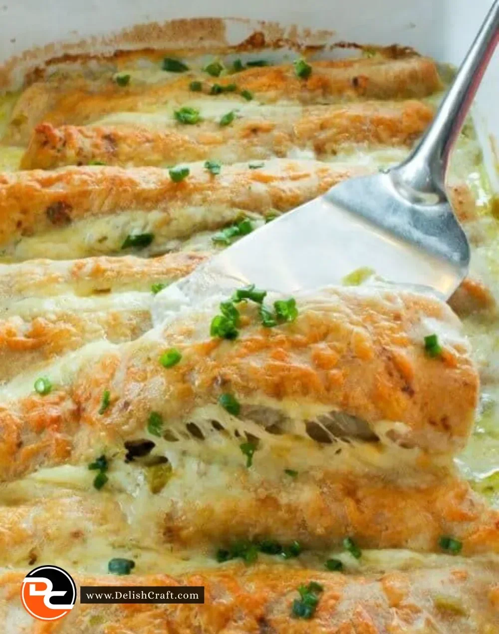 Healthy white chicken enchiladas topped with cheese and green sauce
