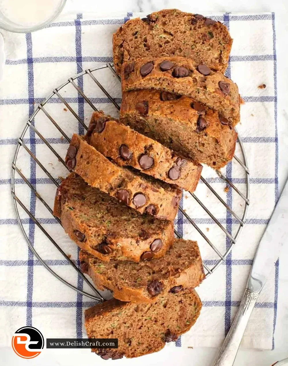 Slice of healthy zucchini bread topped with nuts and a sprinkle of cinnamon