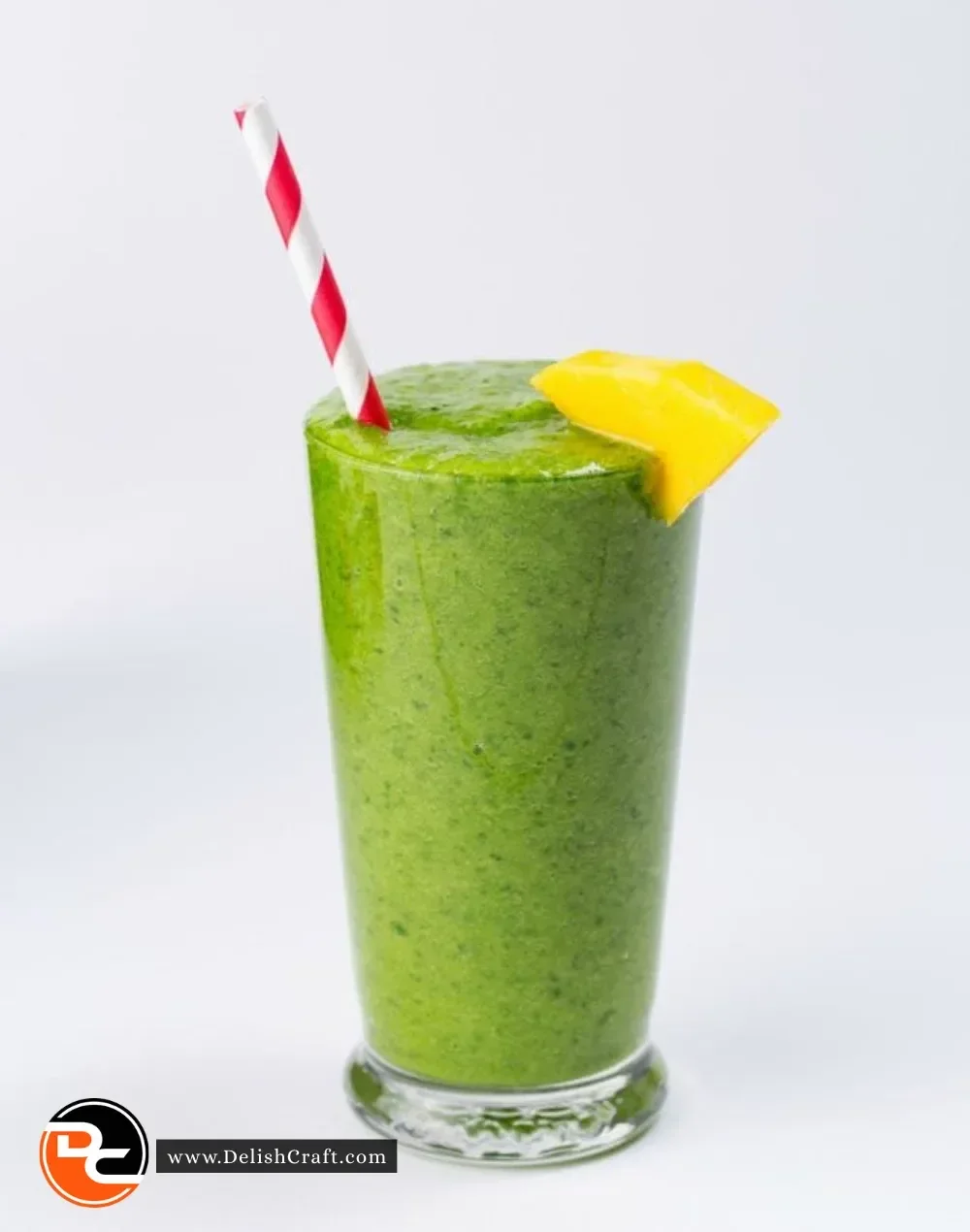 A refreshing green smoothie made with spinach, kale, and fruits in a glass.
