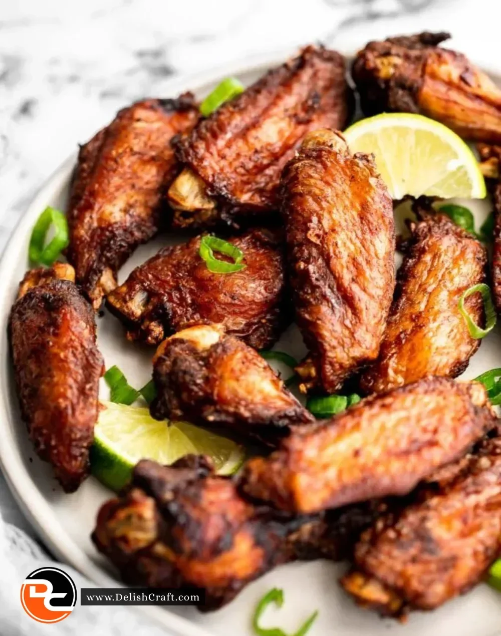 Plate of flavorful jerk chicken wings with vibrant garnishes and dipping sauces.