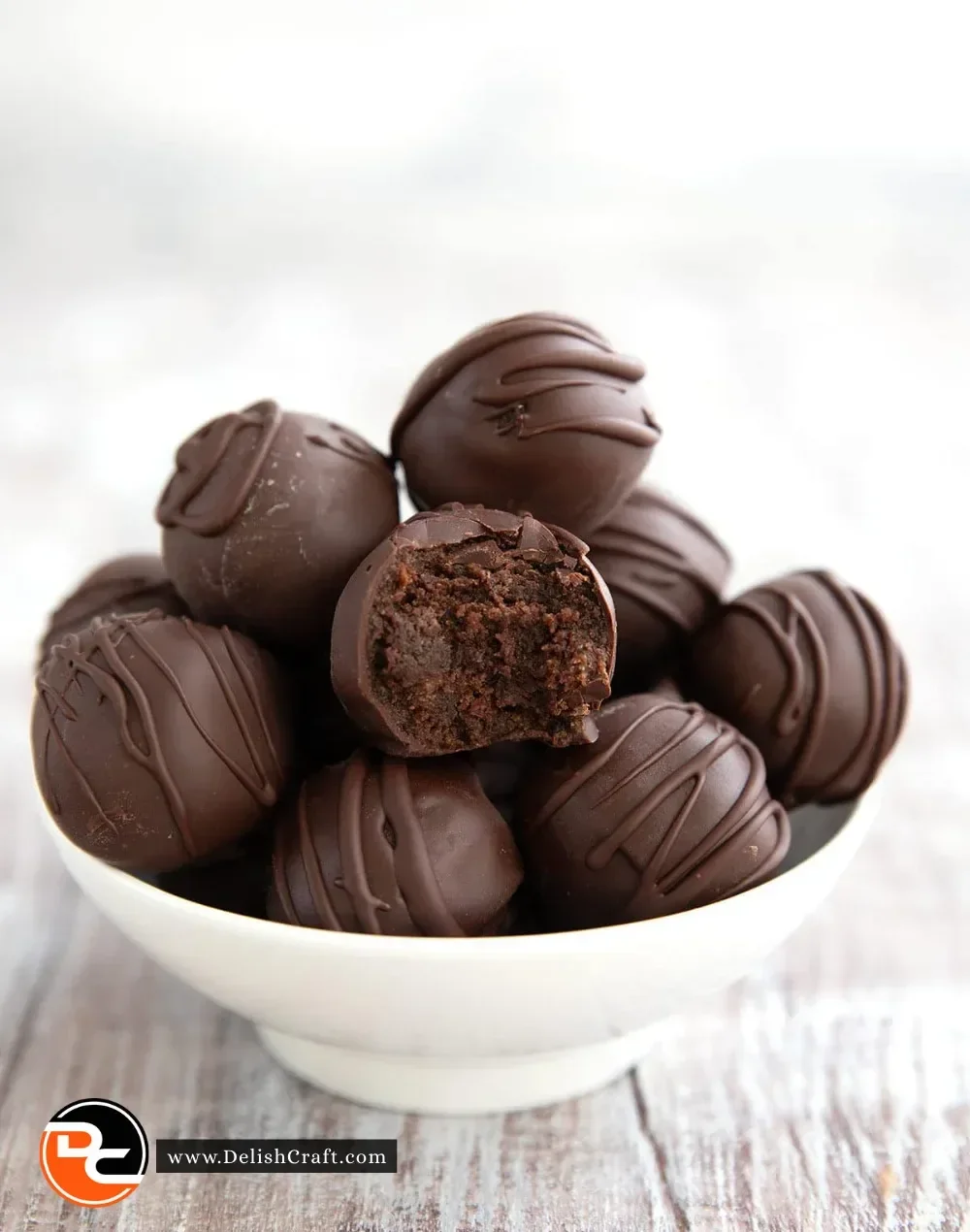 Delicious keto brownie batter truffles topped with chocolate drizzle