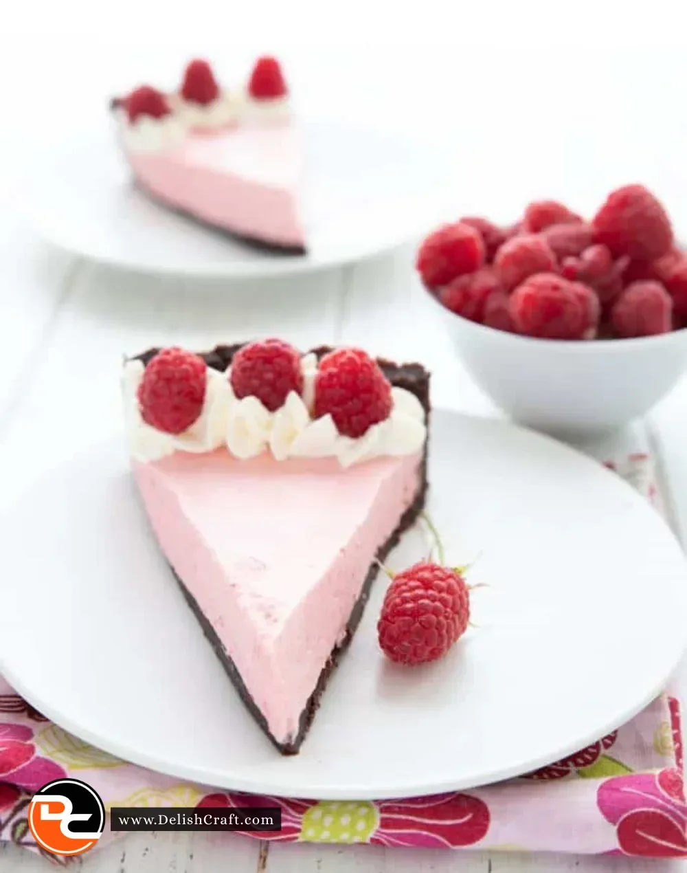 Delicious Keto Raspberry Mousse Tart topped with fresh raspberries